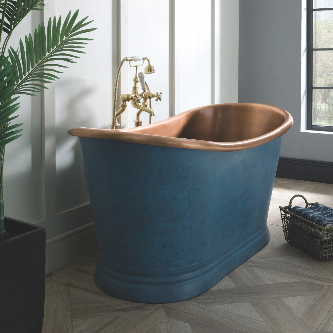 Freestanding bath with soft verdigris patina finish in calming blue tones placed in a luxury bathroom – DDL Tiles